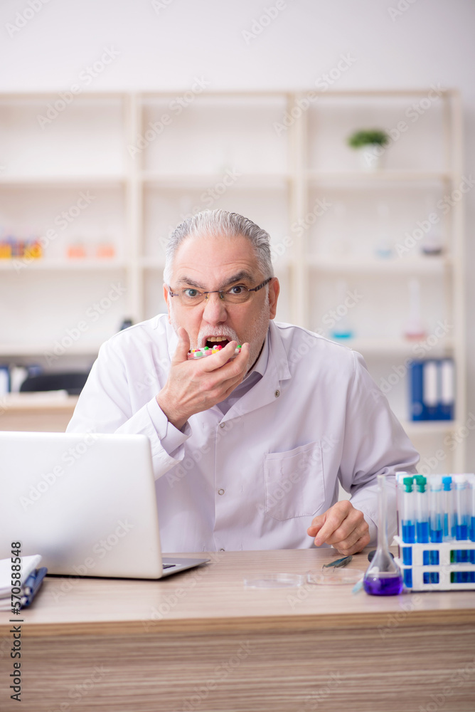 Old male chemist working at the lab Old male chemist working at the lab