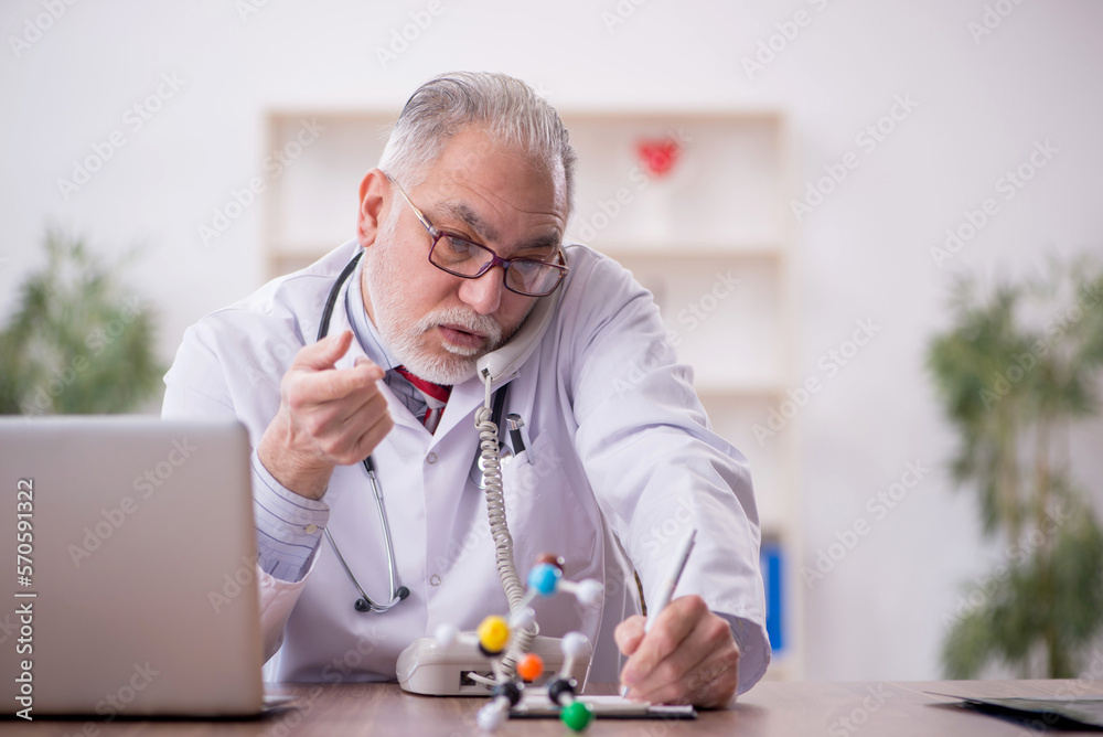Old male doctor in telemedicine concept Old male doctor in telemedicine concept