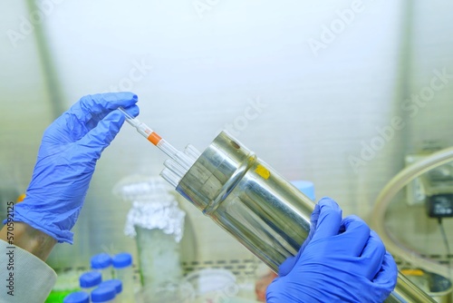 The researcher using sterile serological pipettes size 10 ml are suitable for non toxic solution in cell and bio molecular laboratories. The lab test in the laboratory room. photo
