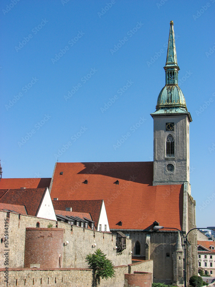 The facade of St Martin's Cathedral, a Roman Catholic church in Bratislava, shot on a clear summer day with a blue sky.  Image has copy space.