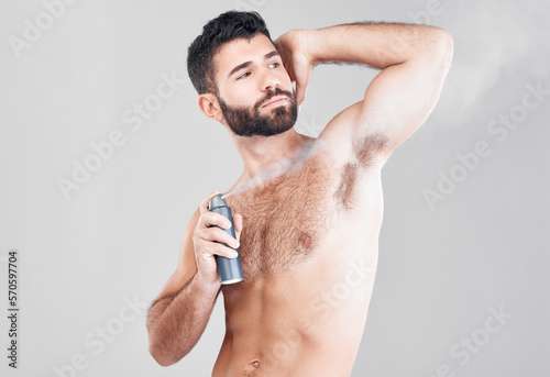 Deodorant, beauty spray and man in studio for hygiene, fresh scent or sweat control. Male model spraying armpit for body odor, smell and cleaning cosmetics, shower product and skincare on background