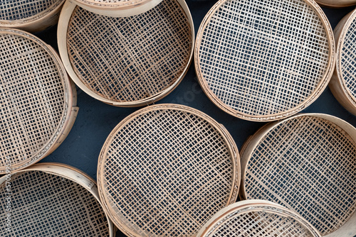 Few Vintage retro sieves for sifting flour and cereals. Background from kitchenware. Set of sieves of various sizes. photo