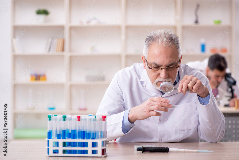 Two male chemists working at the lab Two male chemists working at the lab