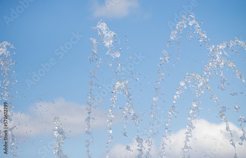splashing water from a fountain against the blue sky
