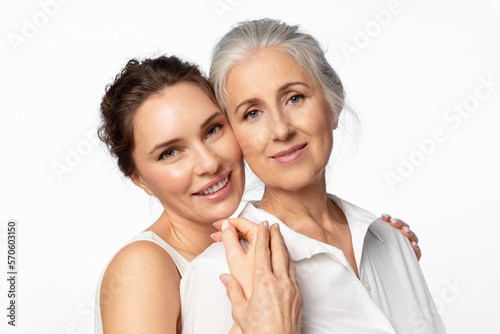 Young beautiful woman and her mother looking happily into the frame together