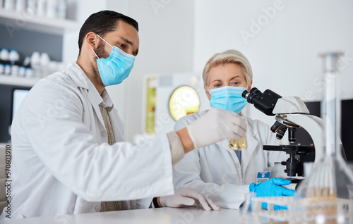 Research, glass beaker and scientists working in laboratory for medical cure or vaccine. Innovation, teamwork and team of professional scientific experts with face mask in pharmaceutical science lab.