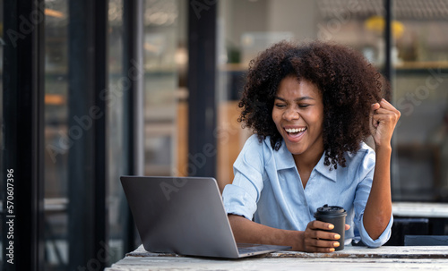 Excited happy african american woman feeling happy rejoicing online win got new job opportunity while using laptop computer.