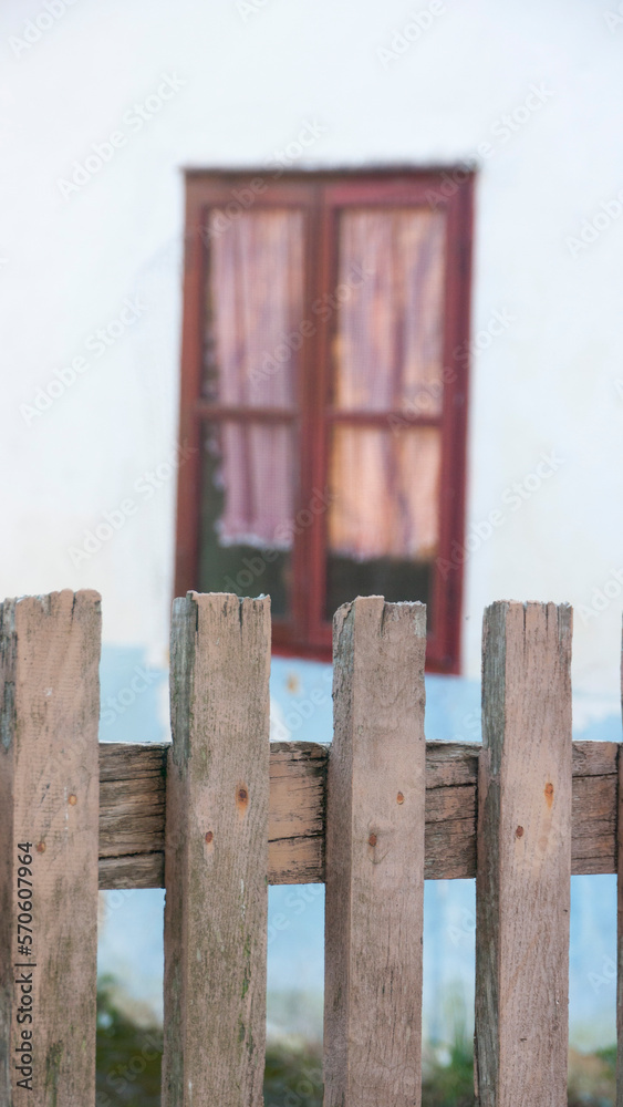 Ventana con marco de madera rojo en casa rural