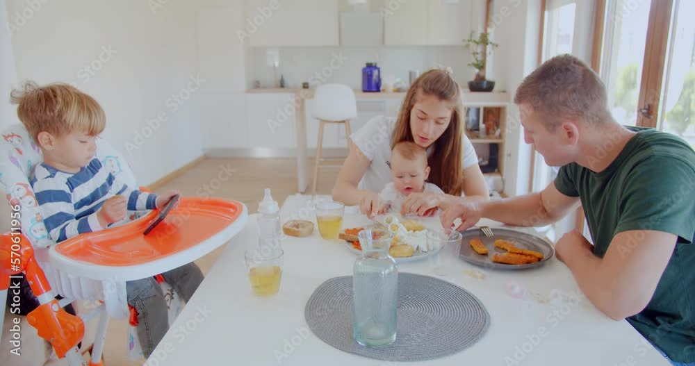 Parents having a good time while eating with their kids Parents having a good time while eating with their kids