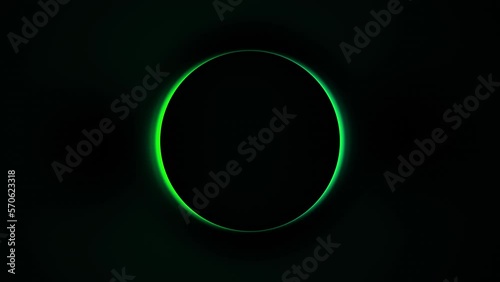 Spinning round glow green shape in dark black backdrop. Loop Footage in 4K with abstract colorful radial form and copy space. Transition to Blackout and Loop included.