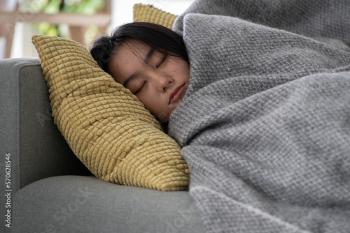 Tableau sur toile Calm tired Chinese Asian girl resting relaxing sleeping on sofa in living room after work relieving negative emotions