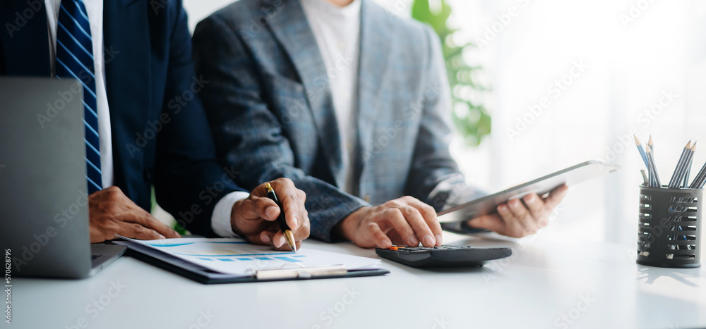 Businessman and team analyzing financial statement Finance task. with smart phone and laptop and tablet. Businessman and team analyzing financial statement Finance task. with smart phone and laptop and tablet.