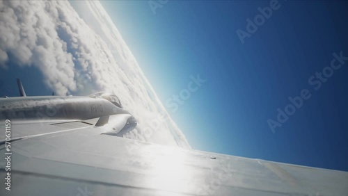 F-18 fighter jet flying above the clouds, armed with missiles. Computer animation photo