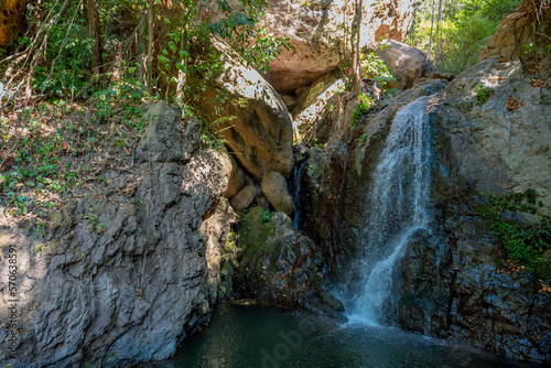 Fototapeta Naklejka Na Ścianę i Meble -  Deep forest waterfall background image.
