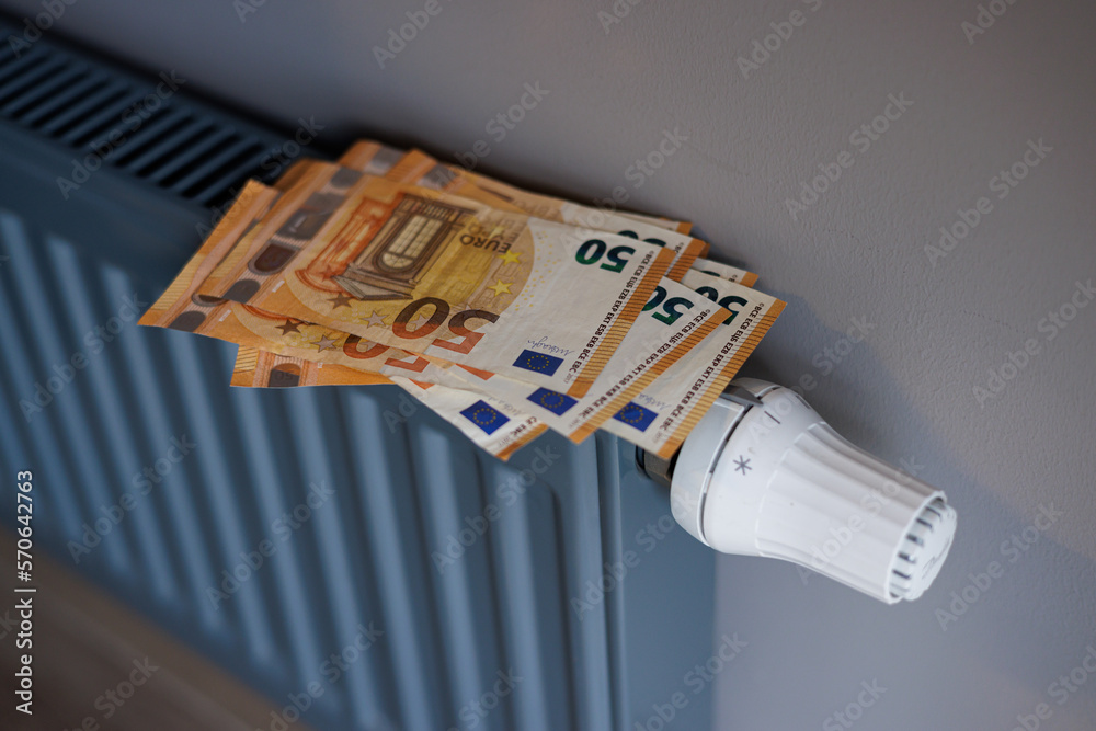 Hands holding money. Cost of heat energy. Price of gas in winter. Euro and rising prices in winter. Europe during winter season. Expensive life and heating bills. Euro banknotes on a cold radiator