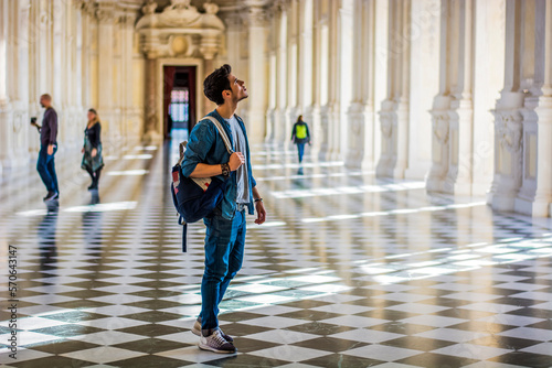 Handsome Man Holding a Guide Inside a Museum