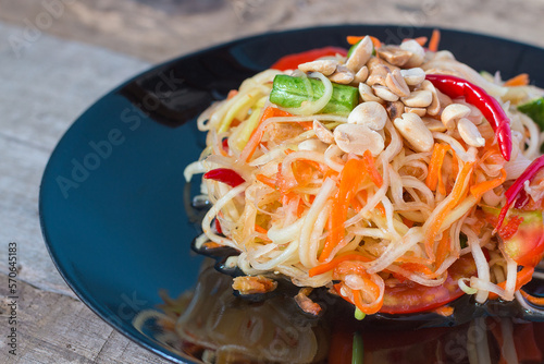 Green Papaya Salad (Som tum Thai) on wood table