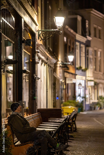 The Hague  Netherlands A man sits at outdoor restaurant tables at night.