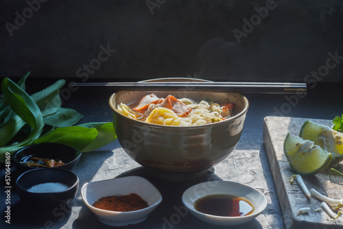 egg noodles with pork wonton soup or pork dumplings soup and vegetable - Asian food style photo