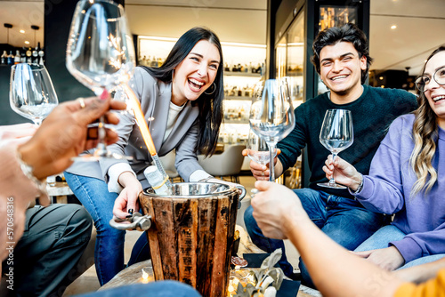 Canvas Print Waiter girl serving bottle of champagne in ice bucket at bar restaurant  table -