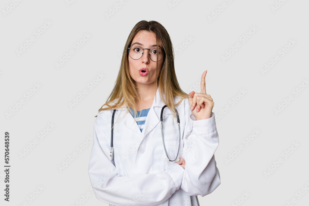 Compassionate female physician with a stethoscope around her neck, ready to diagnose and care for her patients in her signature white coat having some great idea, concept of creativity. Compassionate female physician with a stethoscope around her neck, ready to diagnose and care for her patients in her signature white coat having some great idea, concept of creativity.