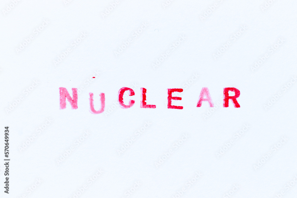 Red color ink rubber stamp in word nuclear on white paper background