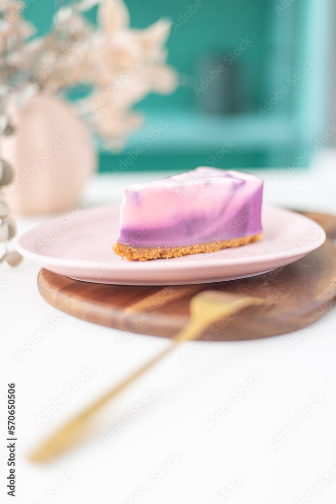 Piece of pink marble cake on a plate with forks and napkin. Bright colour background, close-up. Piece of pink marble cake on a plate with forks and napkin. Bright colour background, close-up.