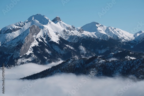 Panorama from rocky peak Gesia Szyja (Gooseneck) in Tatra Mountains in winter scenery. One of the best viewpoints of Slovak Tatras. Tatra National Park, Poland. Interesting phenomenon of inversion. © Iwona