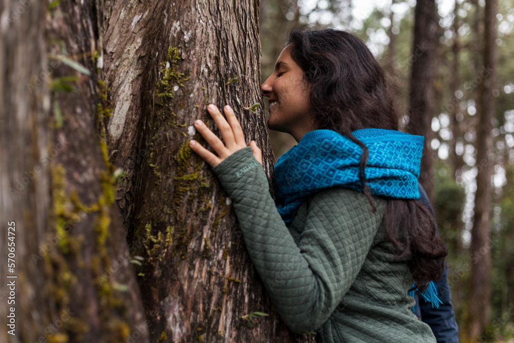 Latin American women hugging a tree and connecting with nature Concept environment, earth day Latin American women hugging a tree and connecting with nature Concept environment, earth day