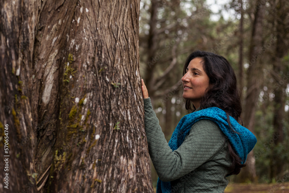 Latin American women hugging a tree and connecting with nature Concept environment, earth day