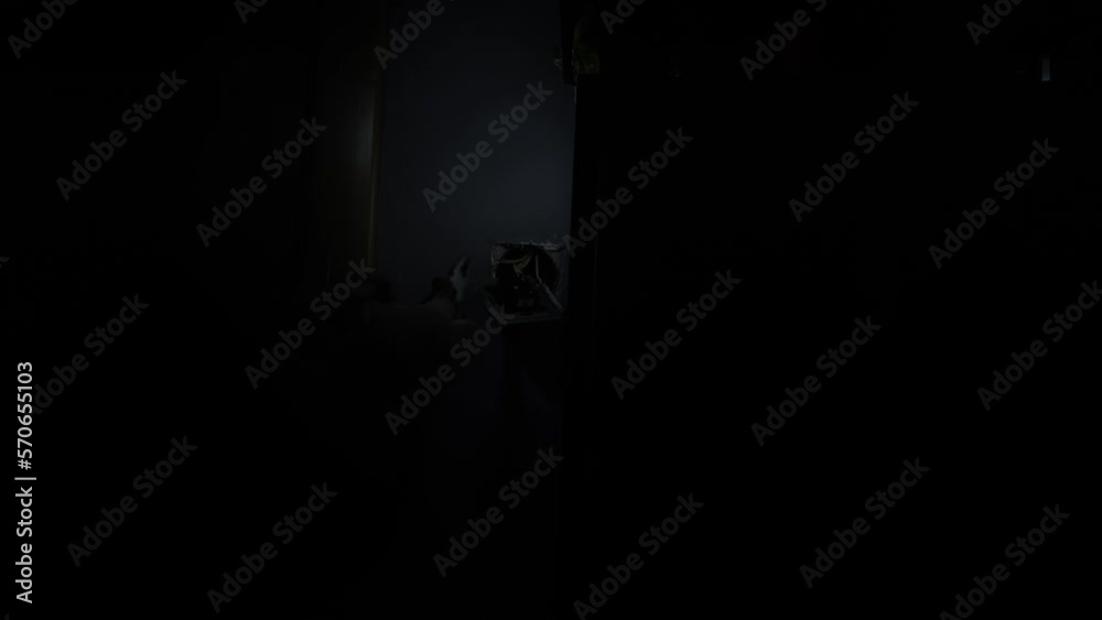 Unrecognizable electrician changing wiring in complete darkness, shining flashlight. Concept of repair by professional specialist. Unrecognizable electrician changing wiring in complete darkness, shining flashlight. Concept of repair by professional specialist.