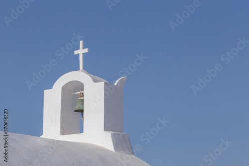 bell tower on chapel on Santorini against clear blue sky