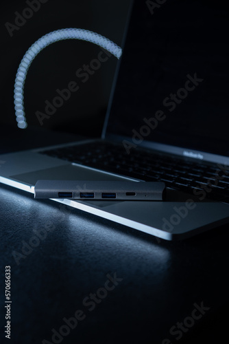 Close-up laptop, type-c hub with cable and usb receiver. Black background. place for inscription for designer
