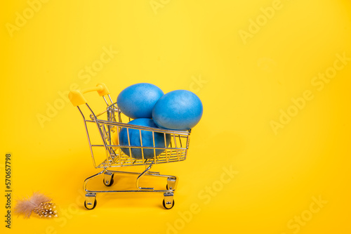 Supermarket trolley with blue easter eggs