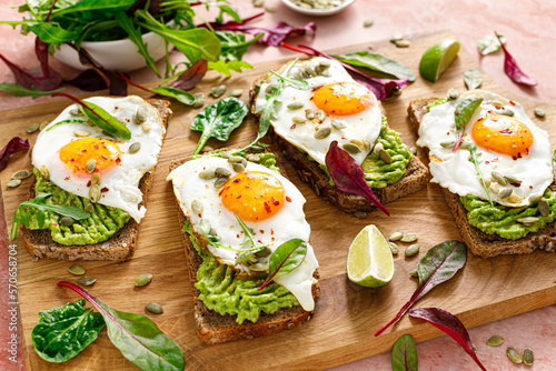 Egg and avocado toast, sandwiches with eggs and fresh greens. Healthy diet food. Top view