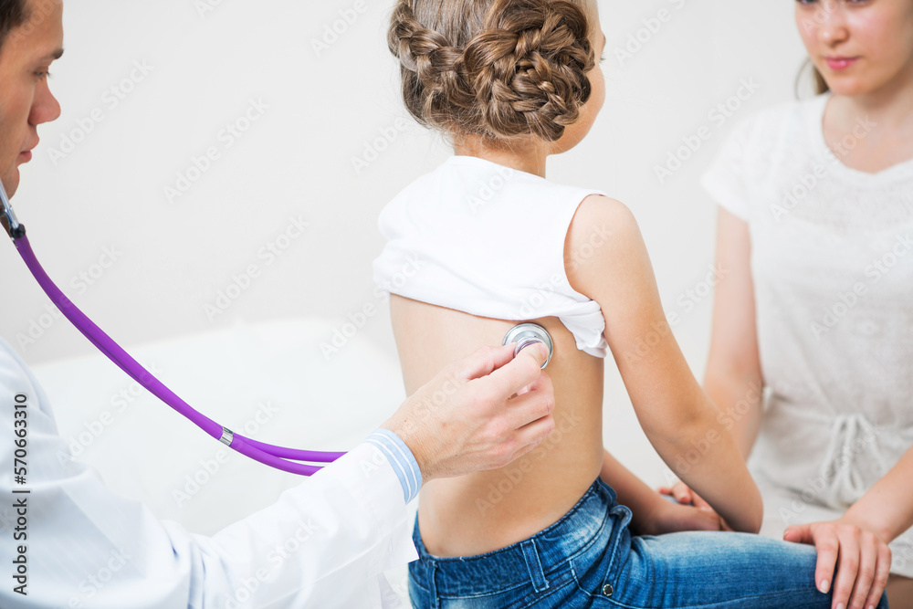 Male pediatrician examining little child Male pediatrician examining little child