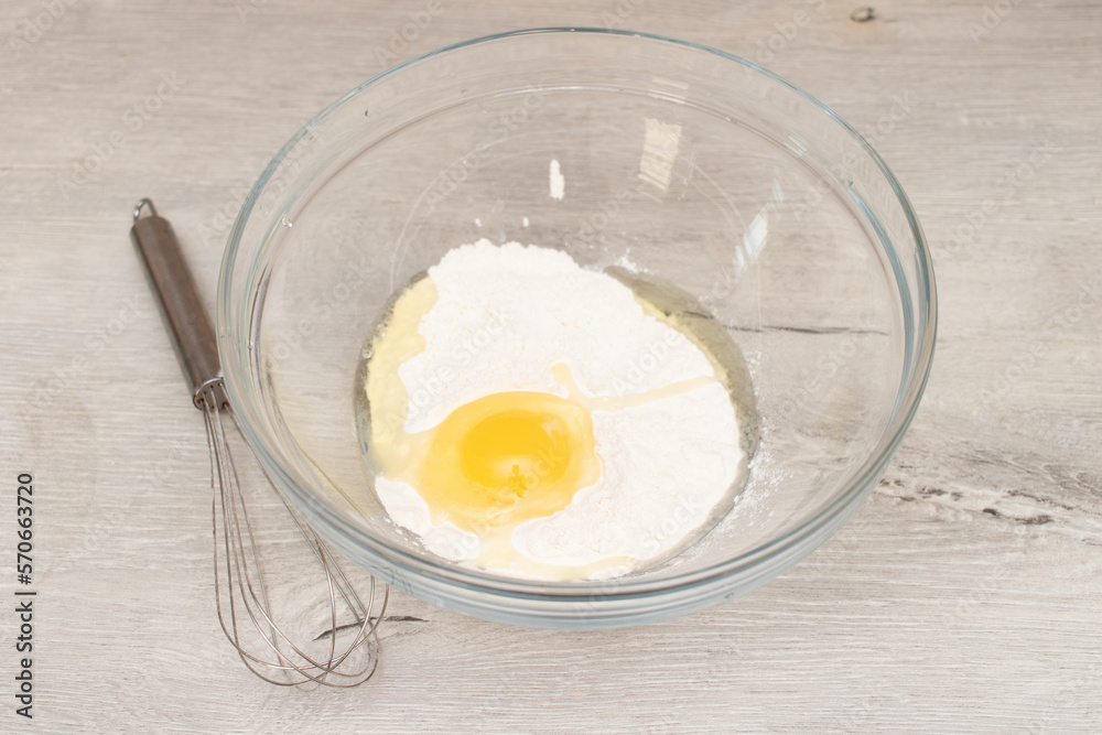 Flour in a bowl, egg and whisk. Preparation of the dough Flour in a bowl, egg and whisk. Preparation of the dough