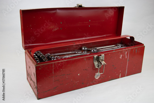 Old red retro handyman toolbox on white background