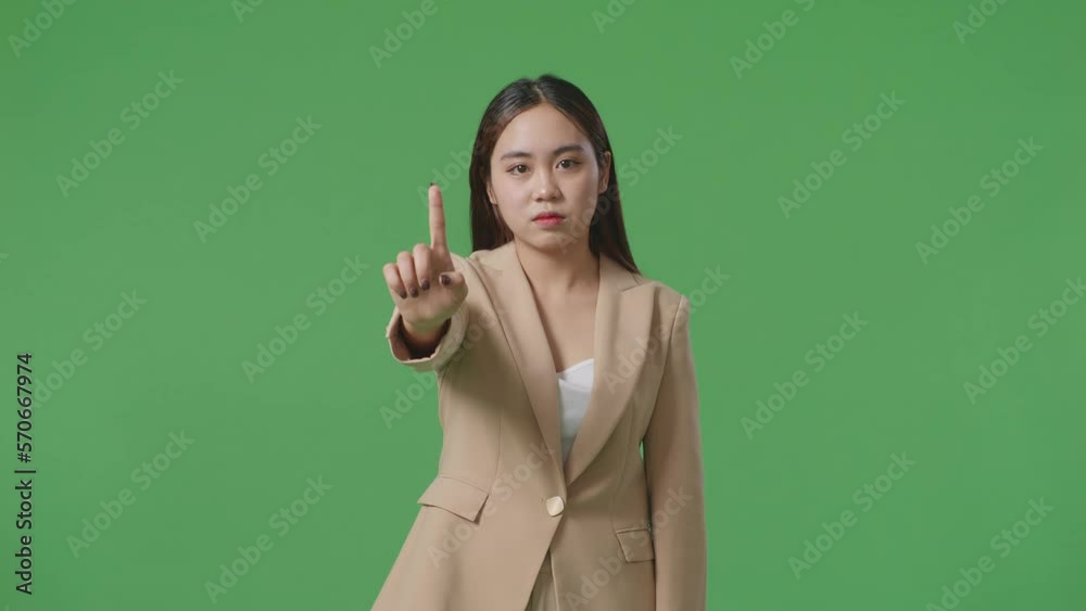 Asian Business Woman Showing Stop, One Finger Gesture, Taboo Sign, Standing On Green Screen In The Studio
Asian Business Woman Showing Stop, One Finger Gesture, Taboo Sign, Standing On Green Screen In The Studio