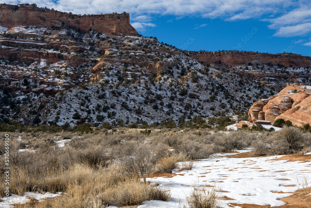 Snow near the west entrance of the Colorado National Monument with cloud shadow creating a dramatic lighting effect