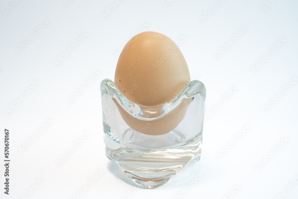 Single brown chicken egg isolated on white background. Food and cooking ingredient concept. Single brown chicken egg isolated on white background. Food and cooking ingredient concept.