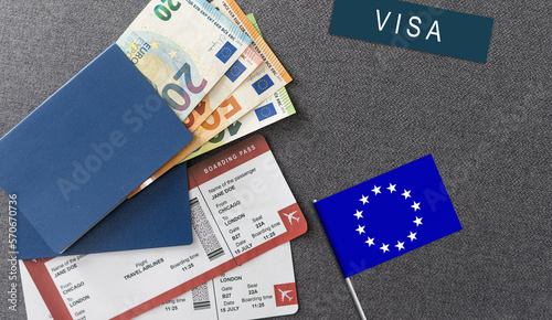 Flag of European Union with passport and toy airplane on wooden background. Flight travel concept