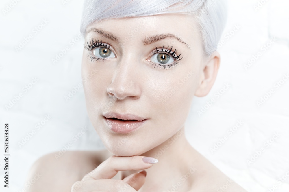 Closeup portrait of beautiful young woman with green eyes and white hair. Closeup portrait of beautiful young woman with green eyes and white hair.