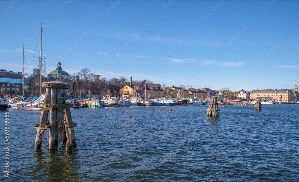 Three remaining dolphins, bollards, in the bay Ladugårdsviken at the island Skeppsholmen a sunny winter day in Stockholm