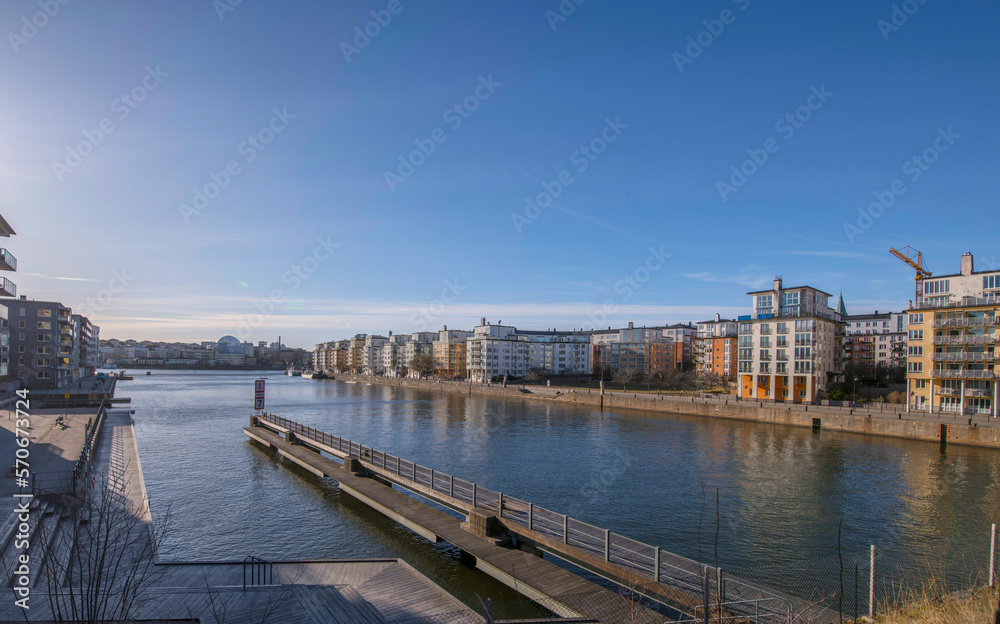Panorama, Piers and waterfront apartment houses at the canal Danvikskanalen in the bay Hammarby sjö a sunny winter day in Stockholm