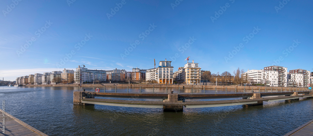 Panorama, Piers and waterfront apartment houses at the canal Danvikskanalen in the bay Hammarby sjö a sunny winter day in Stockholm