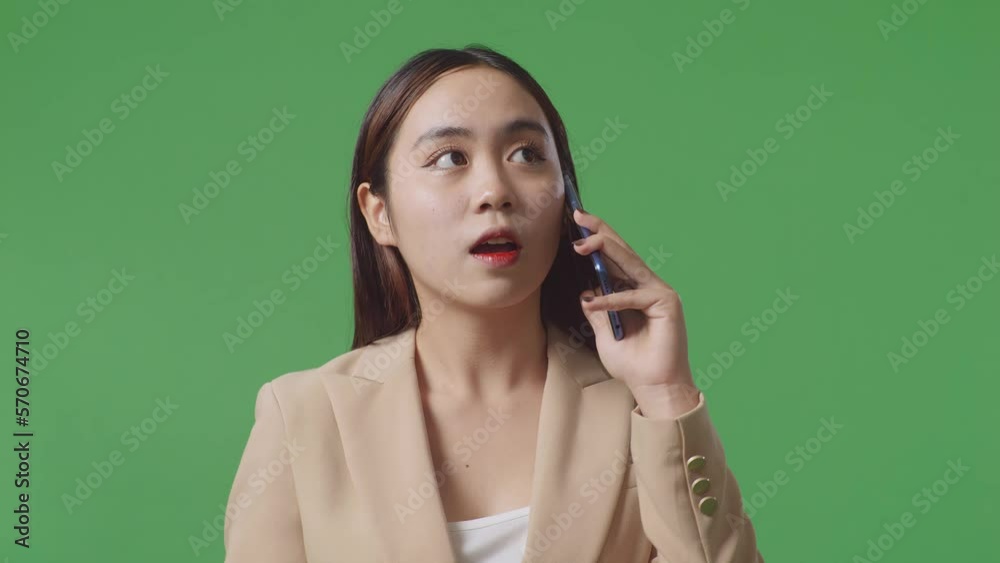 Close Up Of Smiling Asian Business Woman Talking On Mobile Phone On Green Screen In The Studio
Close Up Of Smiling Asian Business Woman Talking On Mobile Phone On Green Screen In The Studio