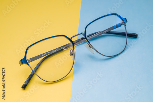 Different types of glasses on an colour background close up. Glasses with round frames. Layout for design.