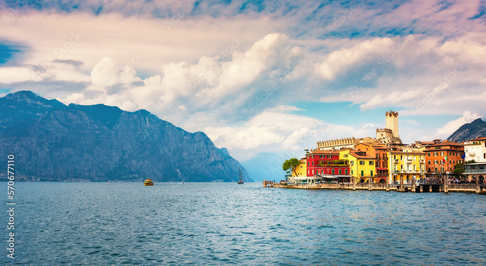 Malcesine, Italy - September 27, 2022:  Ancient tower and fortress in the old town of Malcesine on Lake Garda, Veneto region. Summer landscape with colorful houses and beautiful sky. Traveling concept