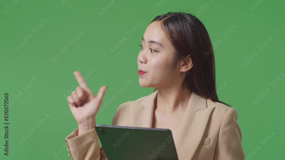 Close Up Of Asian Business Woman Using Tablet And Pointing To The Side On Green Screen Background In The Studio
Close Up Of Asian Business Woman Using Tablet And Pointing To The Side On Green Screen Background In The Studio